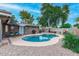 Kidney shaped swimming pool with surrounding gravel and patio furniture at 8325 E Crestwood Way, Scottsdale, AZ 85250