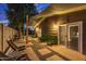 Private backyard patio with seating and shade structure at dusk at 8325 E Crestwood Way, Scottsdale, AZ 85250