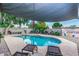 Inviting kidney-shaped pool with a shade sail and comfortable lounge chairs at 8325 E Crestwood Way, Scottsdale, AZ 85250