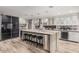 Modern kitchen with large island, stainless steel appliances, and ample counter space at 8325 E Crestwood Way, Scottsdale, AZ 85250
