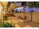 Relaxing backyard patio with shade sail, gravel, and seating at 8325 E Crestwood Way, Scottsdale, AZ 85250