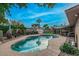 Relaxing kidney shaped pool with surrounding patio and decorative wall at 8325 E Crestwood Way, Scottsdale, AZ 85250