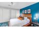 Main bedroom with wood platform bed and blue accent wall at 8325 E Crestwood Way, Scottsdale, AZ 85250