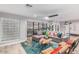 Open living space featuring a comfortable sectional sofa and large windows at 8325 E Crestwood Way, Scottsdale, AZ 85250