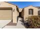 House exterior showcasing a walkway to the front door and attached two-car garage at 19034 W Yucatan Dr, Surprise, AZ 85388