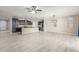 Open concept kitchen with island, dark cabinets, and stainless steel appliances at 19034 W Yucatan Dr, Surprise, AZ 85388