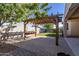 Backyard patio with pergola, artificial turf, and sitting area at 19034 W Yucatan Dr, Surprise, AZ 85388