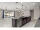 Open kitchen with large island and view to backyard at 19034 W Yucatan Dr, Surprise, AZ 85388