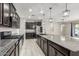 Spacious kitchen featuring dark cabinetry and granite island at 19034 W Yucatan Dr, Surprise, AZ 85388