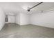 Spacious garage with epoxy flooring and overhead storage at 19034 W Yucatan Dr, Surprise, AZ 85388