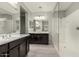 Elegant bathroom with double vanity and glass shower at 19034 W Yucatan Dr, Surprise, AZ 85388