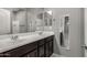 Double vanity bathroom with dark brown cabinets and mirrors at 19034 W Yucatan Dr, Surprise, AZ 85388