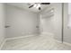 Home office featuring tile flooring, ceiling fan, and built-in shelving at 19034 W Yucatan Dr, Surprise, AZ 85388