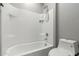 Clean bathroom with a shower/tub combo and tile surround at 19034 W Yucatan Dr, Surprise, AZ 85388