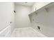 Laundry room with built-in shelving and tile flooring at 19034 W Yucatan Dr, Surprise, AZ 85388