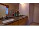 Bathroom with a double vanity, granite countertop, and large mirror at 42715 N Courage Trl, Anthem, AZ 85086