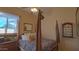 Bright bedroom with a post bed, window, and built-in display case at 42715 N Courage Trl, Anthem, AZ 85086