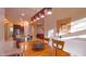 Dining room with wood table, pendant lighting, and kitchen views at 42715 N Courage Trl, Anthem, AZ 85086