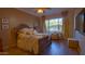 Comfortable bedroom with a large bed, window, and ceiling fan at 42715 N Courage Trl, Anthem, AZ 85086