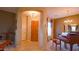 Elegant entryway with wood door and grand piano at 42715 N Courage Trl, Anthem, AZ 85086