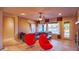 Living room with sectional sofa, red chairs, and access to backyard at 42715 N Courage Trl, Anthem, AZ 85086