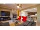Spacious living room with a fireplace, large TV, and comfortable seating at 42715 N Courage Trl, Anthem, AZ 85086