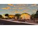 Single-story home with desert landscaping at sunset at 42715 N Courage Trl, Anthem, AZ 85086