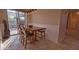 Bright breakfast nook features a wooden table with four chairs, adjacent to sliding glass doors at 42715 N Courage Trl, Anthem, AZ 85086
