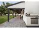 Covered patio with built-in grill and outdoor seating at 88 N Country Club Dr, Phoenix, AZ 85014