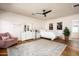 Bright bedroom with hardwood floors, a comfy chair, and plenty of natural light at 88 N Country Club Dr, Phoenix, AZ 85014