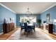 Elegant dining room with a large table, blue walls, and hardwood floors at 88 N Country Club Dr, Phoenix, AZ 85014