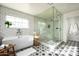 Spa-like bathroom featuring a soaking tub, walk-in shower, and patterned floor tiles at 88 N Country Club Dr, Phoenix, AZ 85014