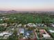 Aerial view of the property, highlighting its location near a golf course and city skyline at 88 N Country Club Dr, Phoenix, AZ 85014