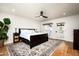 Spacious primary bedroom with hardwood floors, ceiling fan, and access to backyard at 88 N Country Club Dr, Phoenix, AZ 85014