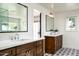 Elegant bathroom with double vanity, large mirrors, and patterned tile floor at 88 N Country Club Dr, Phoenix, AZ 85014