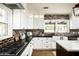 Modern kitchen featuring white cabinets, dark countertops, and a brick accent wall at 88 N Country Club Dr, Phoenix, AZ 85014