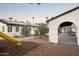 Landscaped backyard with olive trees, a playset, and covered patio area at 88 N Country Club Dr, Phoenix, AZ 85014