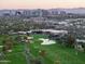 Aerial view of the surrounding area, featuring a golf course and cityscape at 88 N Country Club Dr, Phoenix, AZ 85014