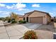 Tan house with two-car garage and landscaping at 1095 W Desert Valley Dr, San Tan Valley, AZ 85143