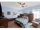 Spacious bedroom with wood furniture and ceiling fan at 1095 W Desert Valley Dr, San Tan Valley, AZ 85143