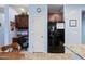 Kitchen with built-in office space and black appliances at 1095 W Desert Valley Dr, San Tan Valley, AZ 85143