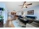 Open living room features hardwood floors, ceiling fan, and adjacent kitchen at 1095 W Desert Valley Dr, San Tan Valley, AZ 85143