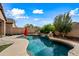 Enjoy this kidney shaped pool with waterfall feature at 1095 W Desert Valley Dr, San Tan Valley, AZ 85143