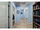 Bright hallway with tile flooring and built-in shelving at 1095 W Desert Valley Dr, San Tan Valley, AZ 85143