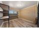 Room with laminate flooring, shelving, and workspace at 5801 E Saguaro Rd, Cave Creek, AZ 85331