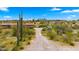 View of a ranch-style house with a gravel driveway and desert landscape at 5801 E Saguaro Rd, Cave Creek, AZ 85331