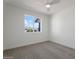 Bright bedroom with ceiling fan and neutral carpeting at 5714 N 19Th Dr, Phoenix, AZ 85015