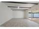 Living room with wood beams, tile floors and sliding glass doors at 5714 N 19Th Dr, Phoenix, AZ 85015