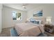 Main bedroom with ceiling fan, large window, and neutral decor at 5714 N 19Th Dr, Phoenix, AZ 85015