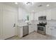 Modern kitchen with white cabinets, stainless steel appliances, and quartz countertops at 5714 N 19Th Dr, Phoenix, AZ 85015